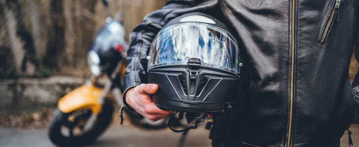 motorcycle rider holding his helmet