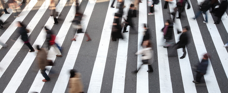 pedestrians crossing a busy street