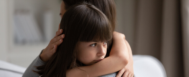 Little girl and mother hugging while upset