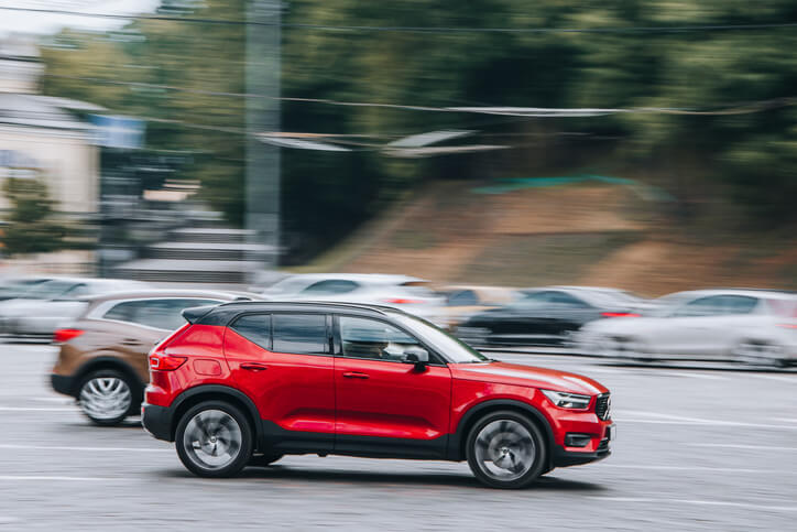 Red Volvo XC40 car moving on the street.