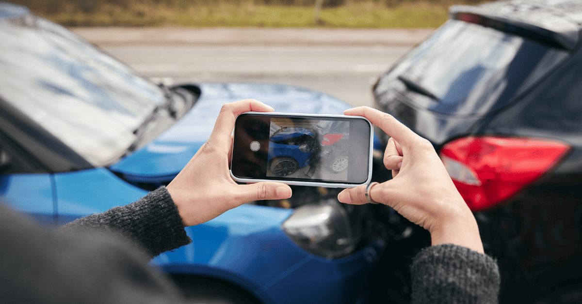 Person taking photos at the scene of an auto accident