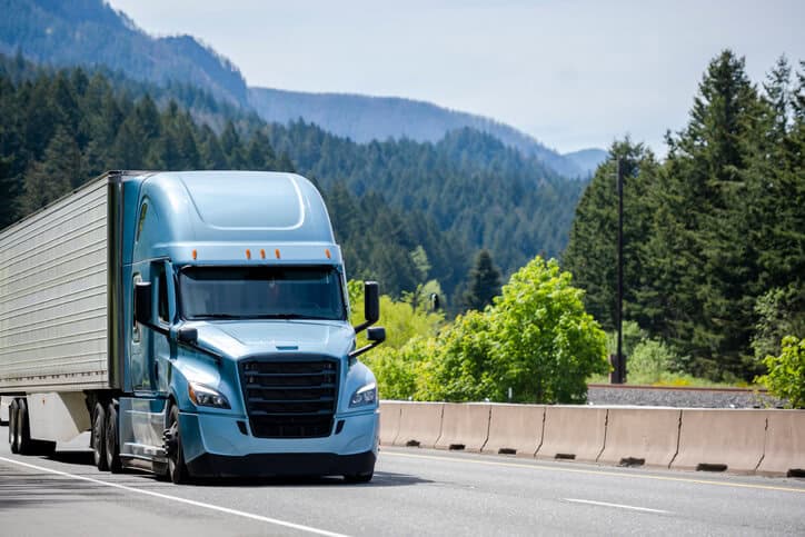 Truck driving down road