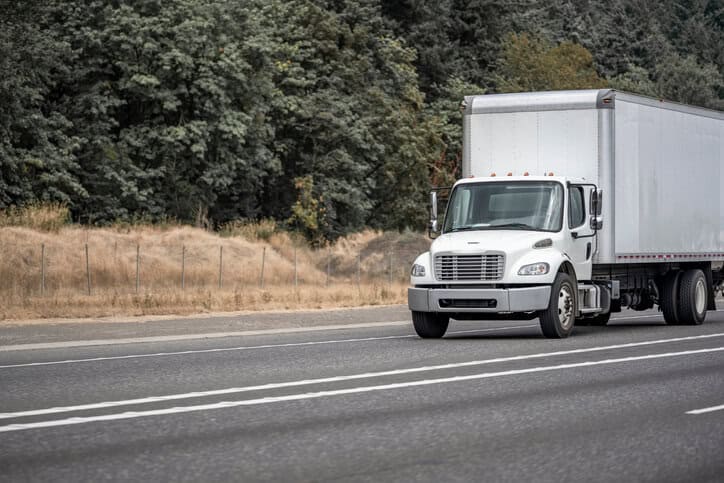Truck driving down road